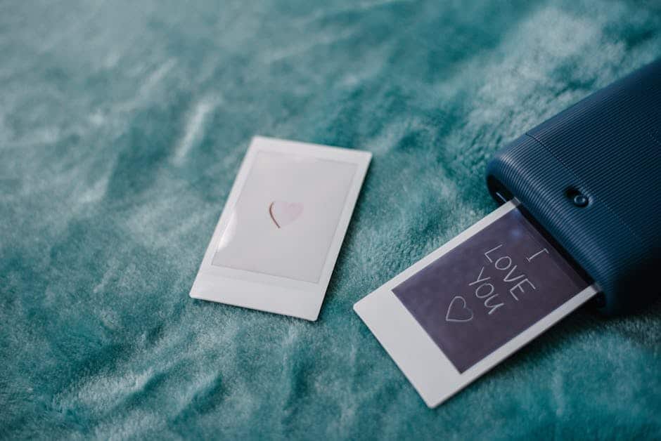 Instant photo printer creating a romantic 'I Love You' message, ideal for Valentine's Day themes.